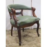A 19th century library/desk chair with horseshoe shaped back, green faux leather upholstered seat