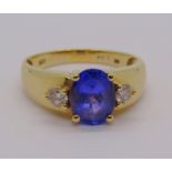 14ct tanzanite and diamond three stone dress ring, size S, stamped 'HOT' to interior, 4g, with