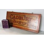 A Cadbury Bournville oak advertisement board, 46cm x 19.5 cm and a 1/4 lb box of Cadbury’s Milk Tray