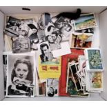 A box containing a quantity of collectors cards including Holywood stars, Shirley Temple, etc.