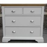 A contemporary partially painted bedroom chest, loosely in the Georgian style, with stripped oak top