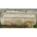 A pair of weathered cast composition stone flower troughs of rectangular form with foliate detail,