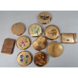 A collection of eleven vintage compacts the majority by Stratton, principally in gold with various