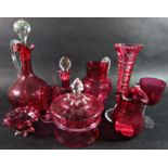 A collection of 19th century cranberry ware, comprising two decanters, two jugs, a vase, two glasses