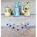 Three enamel coffee pots and ten wine glasses with blue mottled waisted stems.