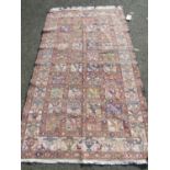 A Persian Soumak kilim rug with repeated animal design in pale primary tones of red, yellow, blue