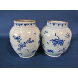 A pair of 18th century Chinese baluster shaped vases with repeating floral detail, 26cm high