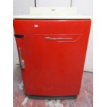 A vintage Frigidaire refrigerator, in red, with white enamel work surface