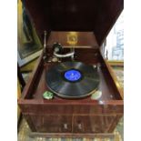 An early 20th century HMV wind up wooden gramophone with a pair of volume doors to the front.