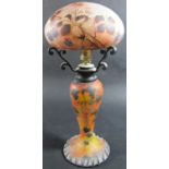 An Art Nouveau opaque autumnal berry decorated table lamp signed Peynaud, the glass shade