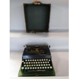A German Adler 30 typewriter, with forward striking keys, in its ordinal carrying case.