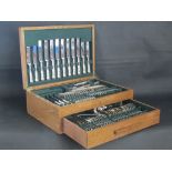 An oak canteen of silver plate shell patterned cutlery for eight settings, complete, made by  John B