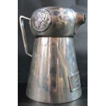An arts and crafts silver jug of lobed conical form with an angled handle and pinched square