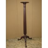 A Georgian style mahogany torchere with reeded column