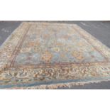 A Very Large Middle Eastern Rug with repeated pattern in blue, brown and green tones, 620 x 370 cm