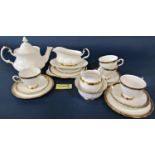 A Tuscan bone china tea service with white ground within black and gilt Greek key borders,