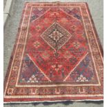 A North West Persian Josheghan rug with central diamond medallion and repeated floral patterns in