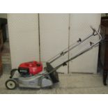 A Honda HR173 petrol driven rotary lawn mower with rear roller, complete with grass collection bag