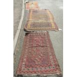 Three worn Middle Eastern rugs, all wool on wool with central repeated designs in magenta, iron-red,
