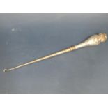 A silver handled button hook with cherub decoration, London 1896, makers mark rubbed, 34.5cm long
