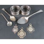 Two silver napkin rings, three silver medallions, two spoons, 2.45oz approx, together with a
