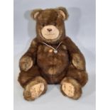 Large sitting grizzly bear by Steiff with luxurious brown fur and tan muzzle, with tag and pin in