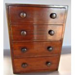 An early 20th century mahogany desk top bank of graduated filing drawers 30cm high x 23cm