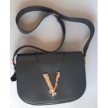 Versace Virtus Saddlebag in black leather with cross body strap, V logo and magnetic closure, with