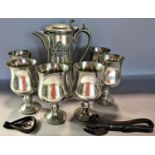 A pewter claret jug bearing the badge of the Royal Military Police and six goblets, a vintage tin