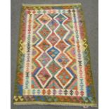 A Chobi kilim with repeated geometric diamond design in multicoloured tones, 152cm x 100cm approx