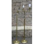 A pair of contemporary three quarter height standard lamps with brass effect tubular stems