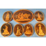 Seven 19th century Southern European oval wooden inlaid plaques depicting scene of everyday market