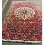 A Large Persian Bakhtiari Rug with shah abbas design in tones of crimson, indigo and natural wool