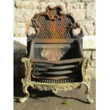 An antique style cast iron and brass fire basket with scrolling acanthus and further decorative