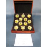 Cased set of twelve gold plated medallions, Racing Legends Medallion Collection, Danbury Mint,