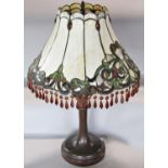 An Art Nouveau “Tiffany” style table lamp with “lead” floral panelled shade with facetted drops,