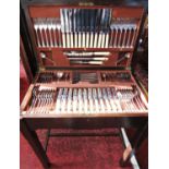 An early 20th century oak canteen table of cutlery complete for twelve settings.