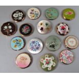 A collection of fifteen vintage compacts, the majority by Stratton, with floral themes, various