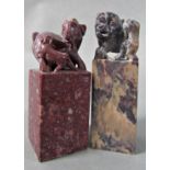 Two Chinese soapstone seals, with dog of fo and other surmounts