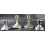 A pair of squat candlesticks, Sheffield 1910, maker Thomas A Scott, 10cm high, together with a