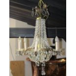 A gilt framed six branch chandelier, festooned with faceted drops, 80 cm drop approximately