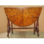 A Victorian figured and burr walnut veneered oval drop leaf Sutherland table on spiral supports