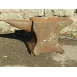 A small but heavy cast iron anvil with two cut out/pierced receptacles, 48cm long x 24cm high