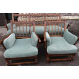 An Ercol Colonial three piece suite comprising three seat sofa and a pair of matching armchairs with