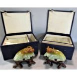 A pair of celadon and russet jade recumbent water buffaloes on carved wooden stands, in original