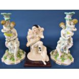 A pair of 19th century continental porcelain candle bases with mother and child and a Florence resin