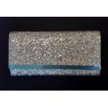 Glitter clutch bag by Jimmy Choo, appears unused, with press stud clasp, gold chain shoulder