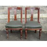 A set of six late Victorian stained oak dining chairs
