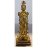 A Chines gilt bronze figure in ceremonial clothing on a square base, 12.5cm high.