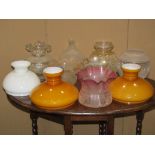 A collection of vintage oil lamp shades of varying design